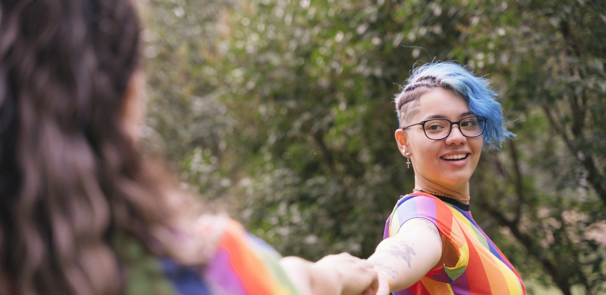 Youth with Blue Hair and rainbow shirt